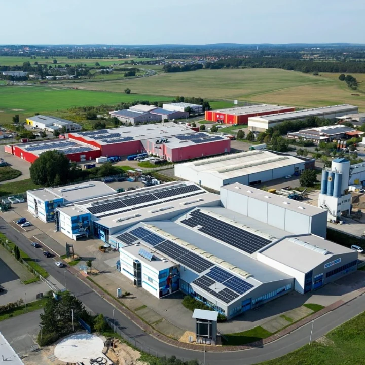 Aerial view of Metallbau Windeck's industrial site with production halls and rooftop solar panels.